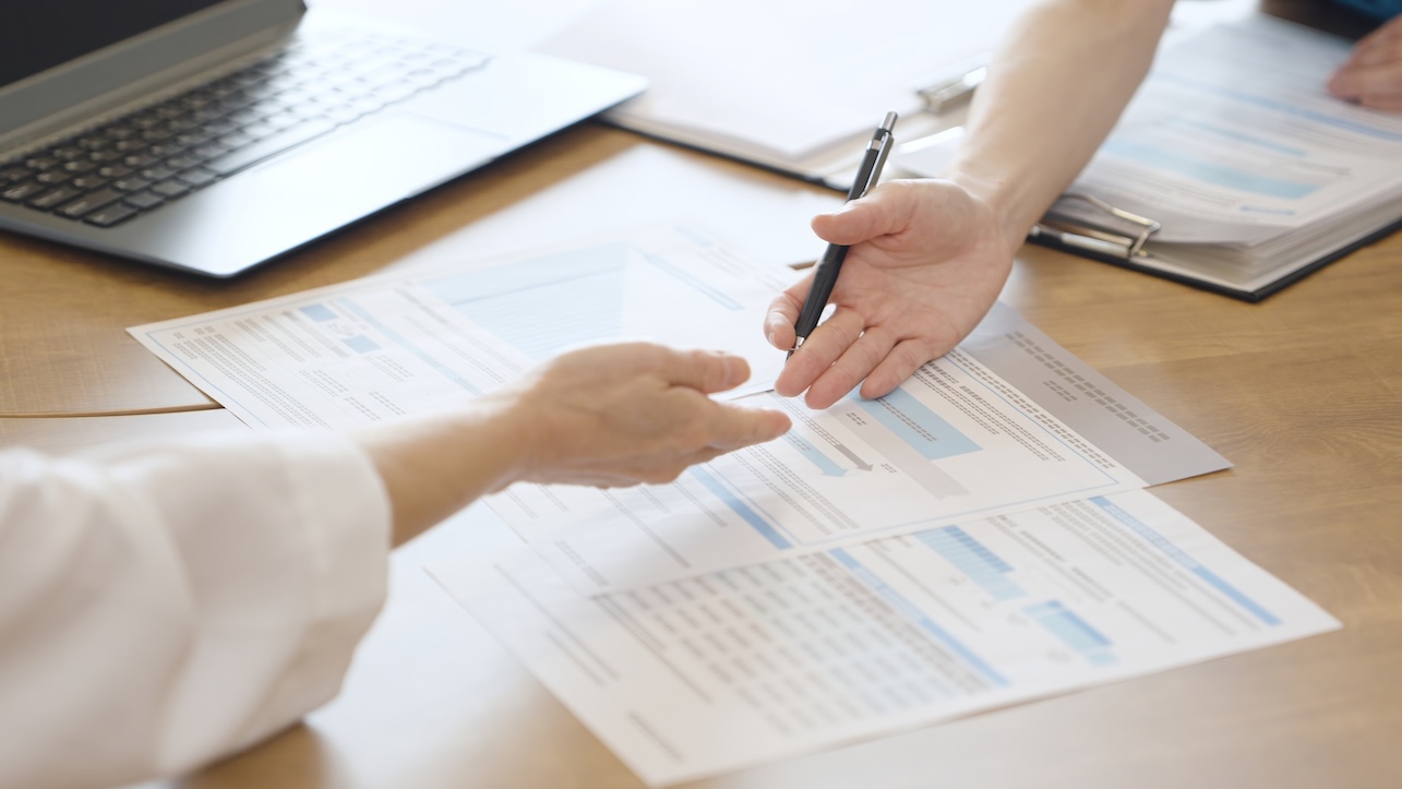 Caregiver explaining about medical care costs to a worried patient